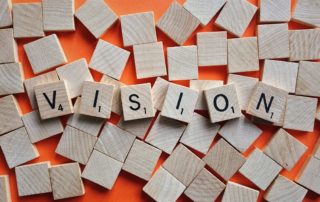 Scrabble tiles forming the word VISION